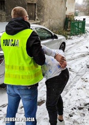 policjant prowadzi zatrzymanego